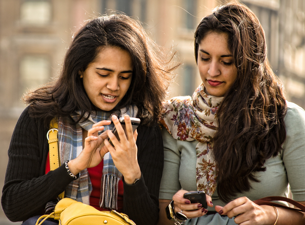 two women with cell phones