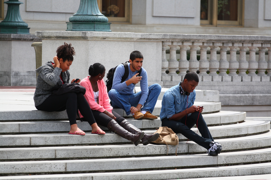 people sitting with their phones