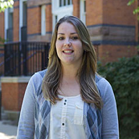 Laura Gonzales stands in front of a building