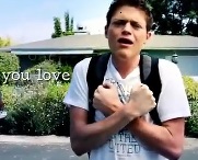 A young man is signing the word love. On screen are the lyrics "you love."