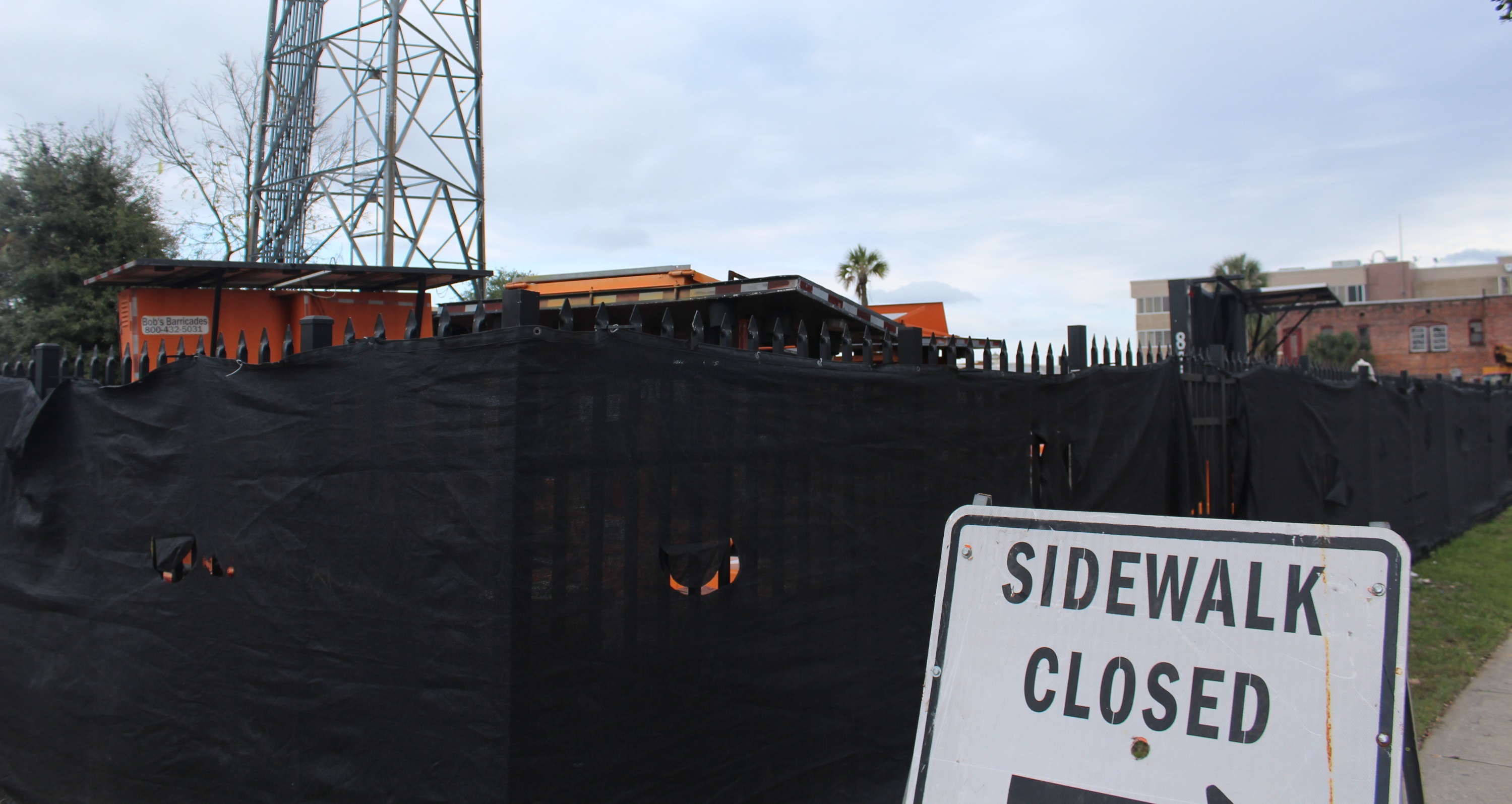 background image, sign reading 'sidewalk closed'