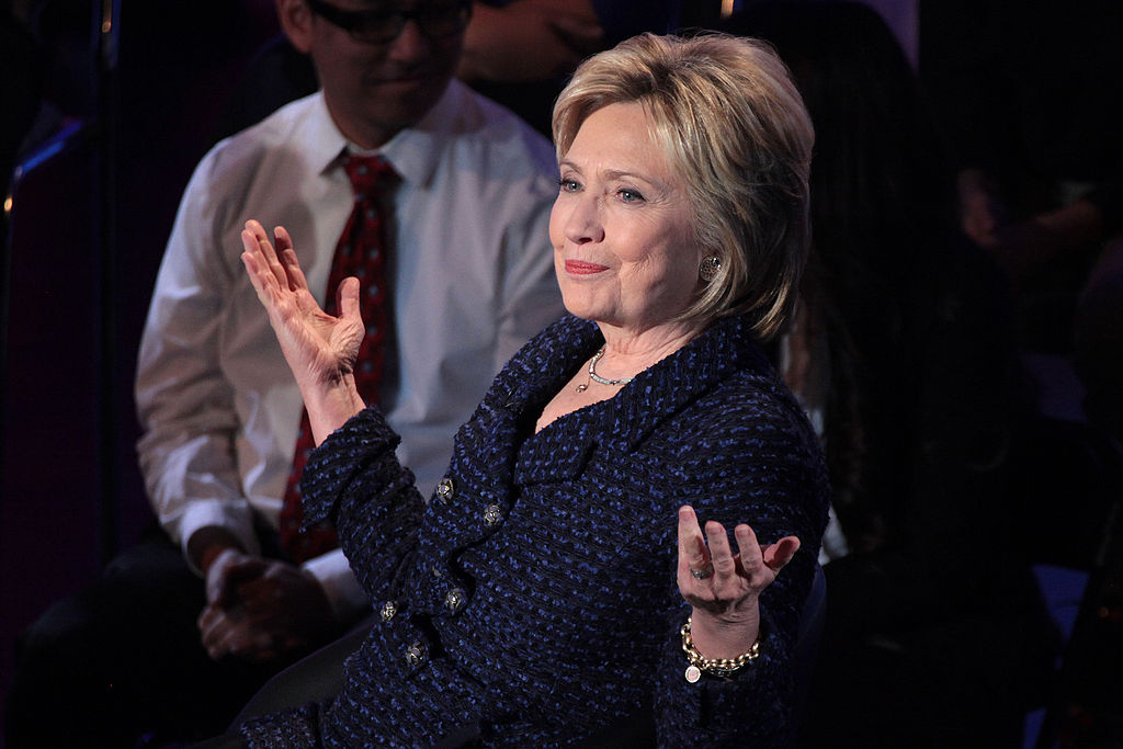 image of Hillary Clinton photo by Gage Skidmore. Clinton wears bracelet with image of her granddaughter