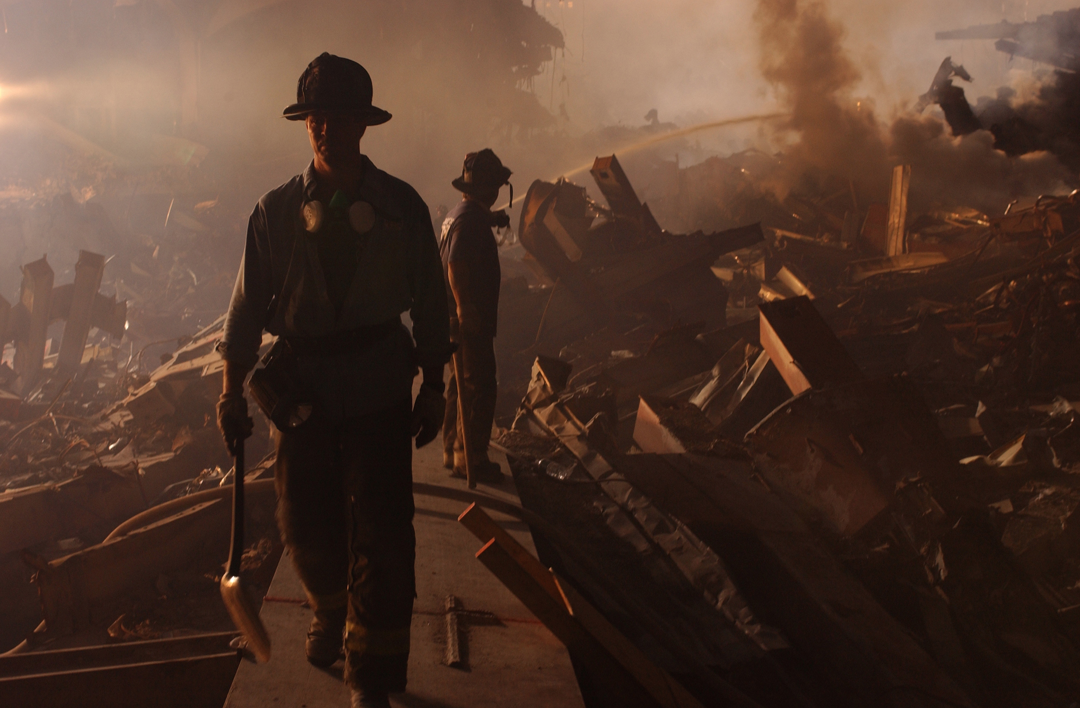 Members of Fire Department New York work to extinguish flames in the aftermath of September 11, 2001.