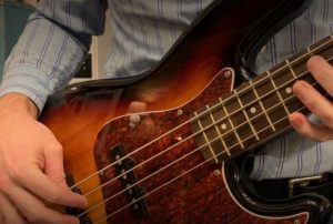 closeup of one author, Bill, playing electric bass